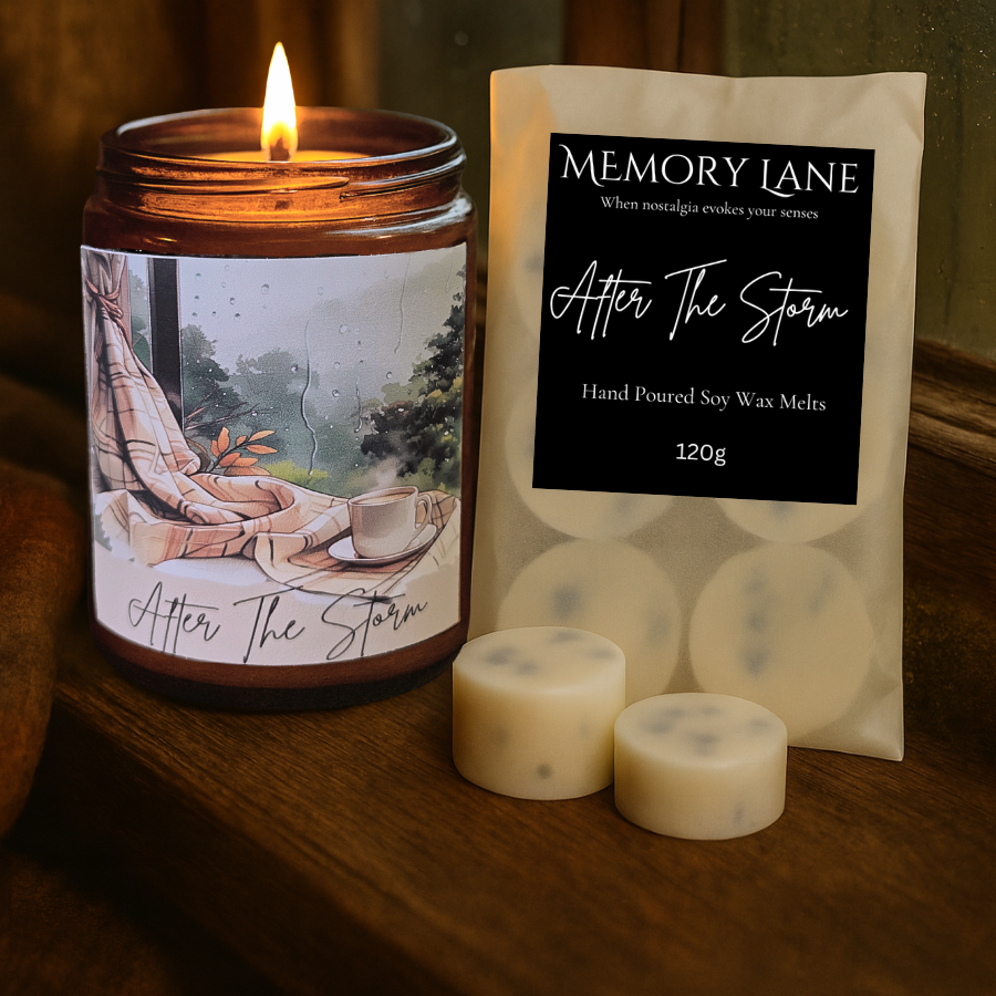 Candle labeled 'After The Storm' and packaging of 'Memory Lane' soy wax melts on a wooden surface.