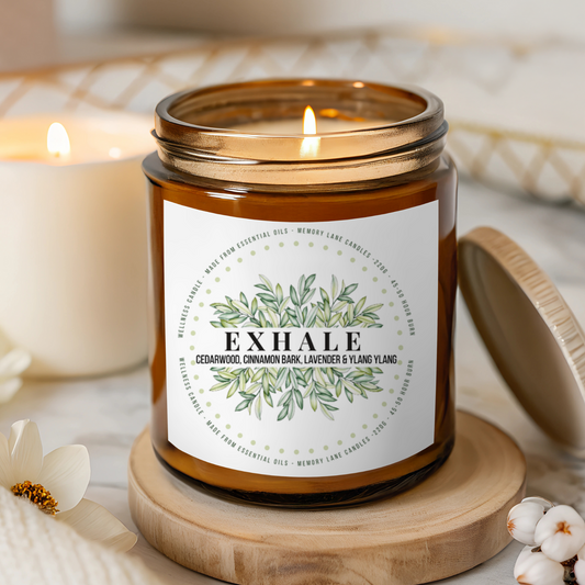 Candle labeled 'Exhale' on a wooden coaster with a blurred background