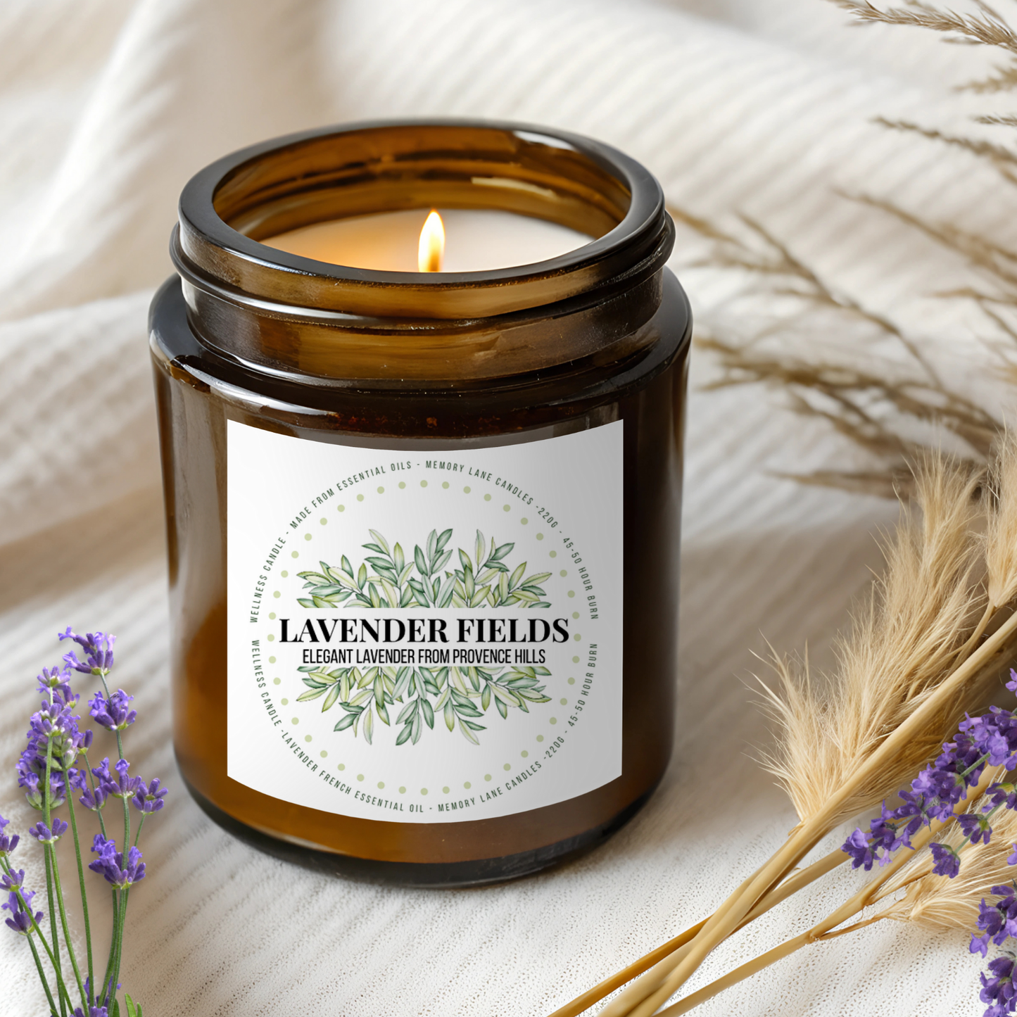 Candle in an amber jar labeled 'Lavender Fields' with lavender and wheat on a light background