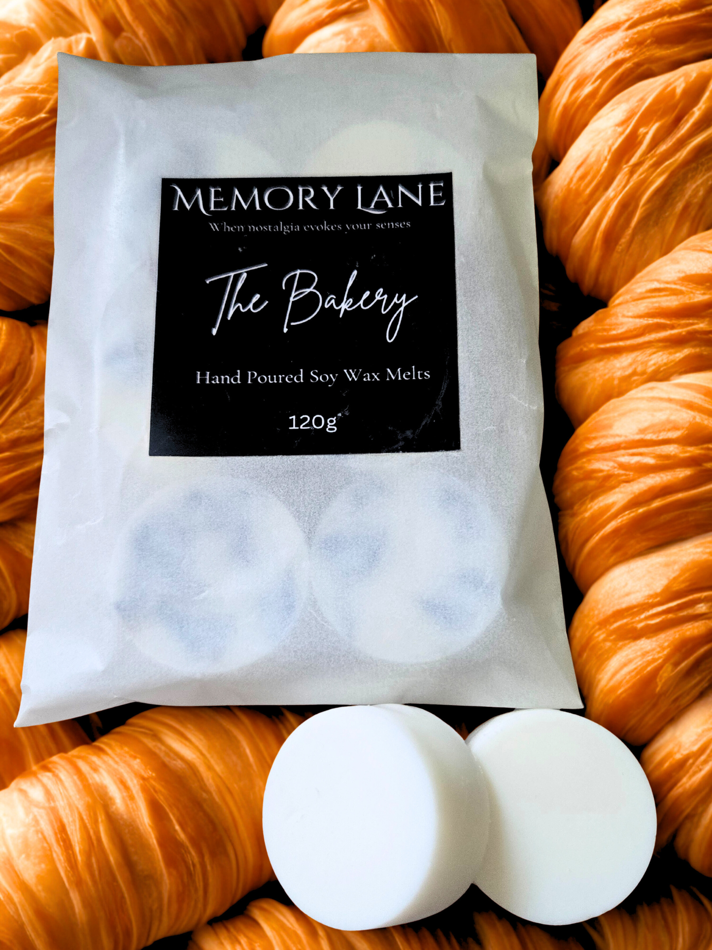 Packaging of Memory Lane The Bakery hand poured soy wax melts with croissants in the background.